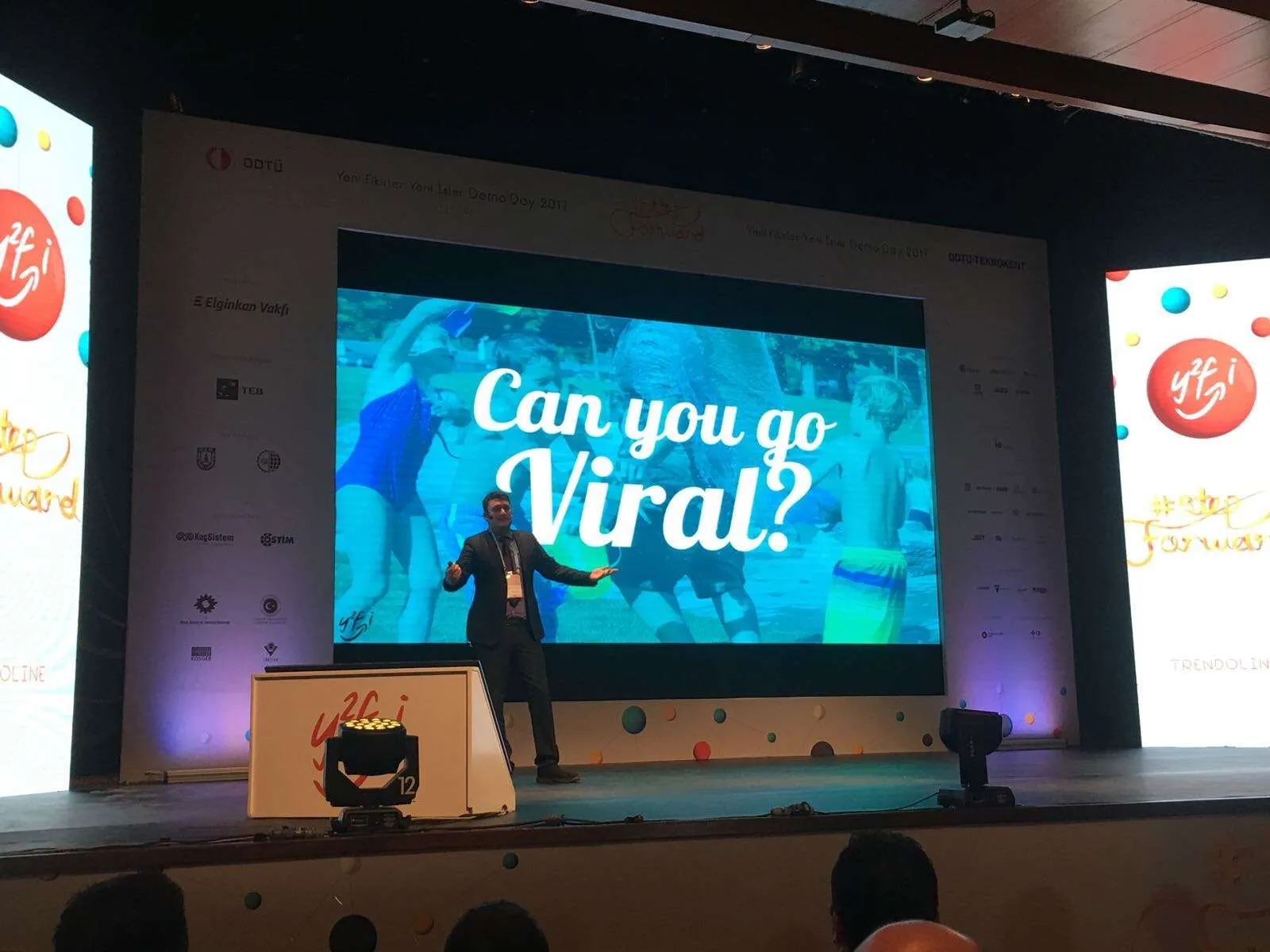 Ashkan speaking on stage